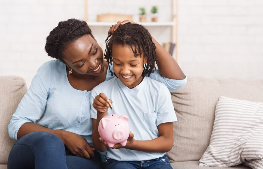 mother and daughter using piggy bank