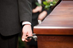 man hand holding casket