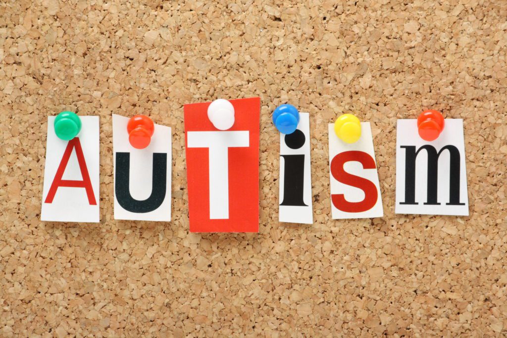 autism spelled on corkboard