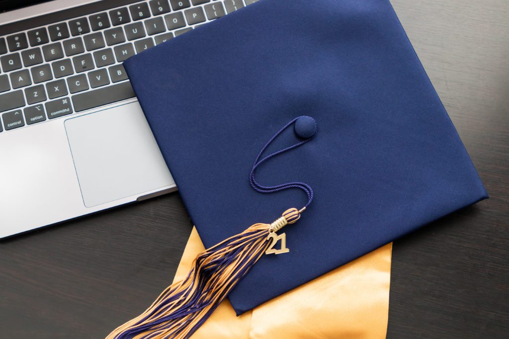 cap and gown on laptop