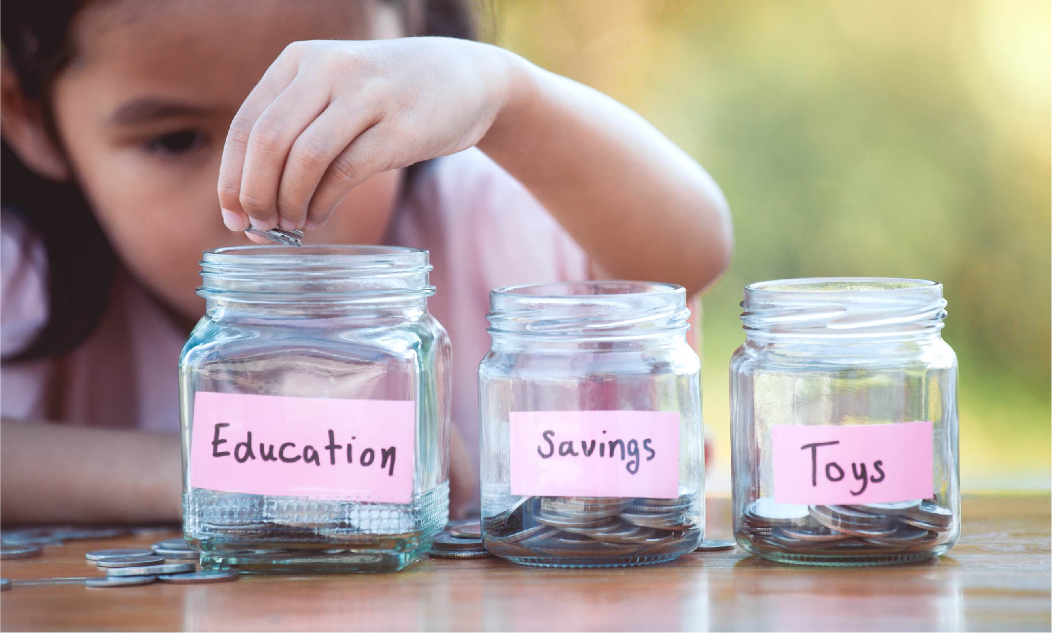 child saving money jars