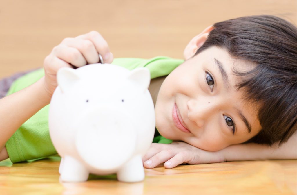 young boy with piggy bank